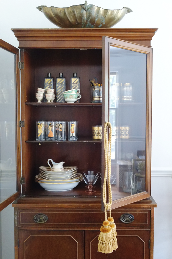Victorian china cabinet with mid-century modern barware inside