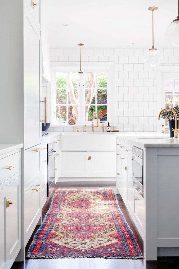 Favorite Kitchens of 2015 - How amazing is this vintage persian colorful rug in this all white kitchen. Holy pop of color!