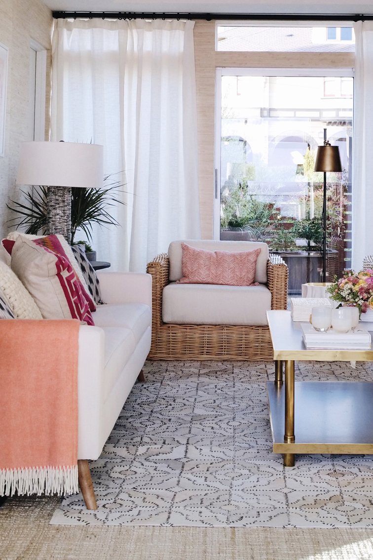 I love the beachy feel of this room with the white and rattan. The stitched layered hide rug was gorgeous. See more on House Of Hipsters blog. 