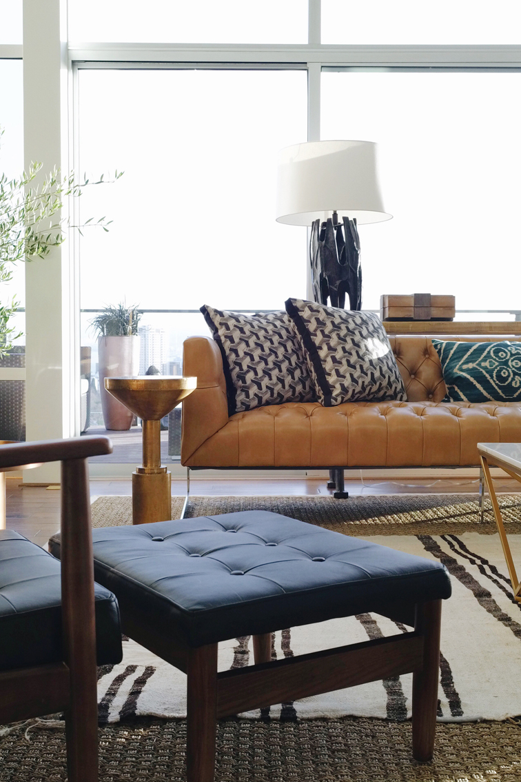 Living room Mid Century Modern inspired design. Love the layered rugs and the leather camel colored sofa. Seattle Showhouse. Interior design by Decorist with ATGstores.com and Porch. Click to see more of the House on House Of Hipsters blog. 