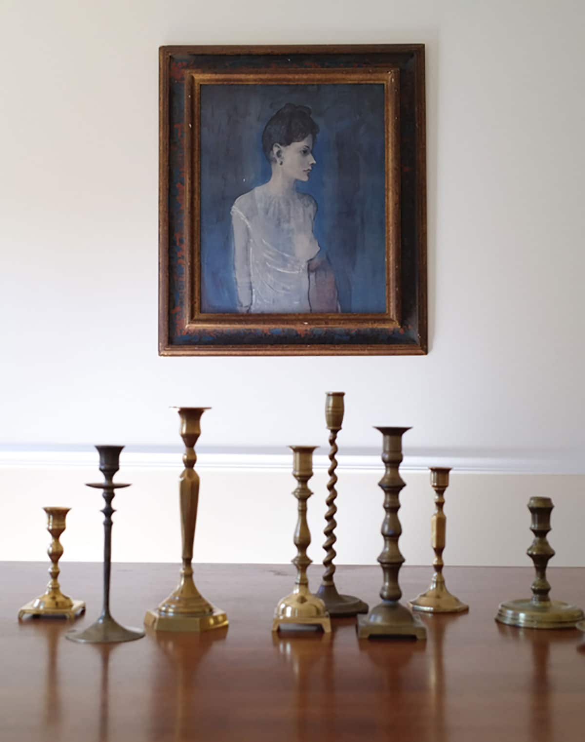 Girl in a Chemise Pablo Picasso portrait. Vintage brass candlesticks in my dining room.