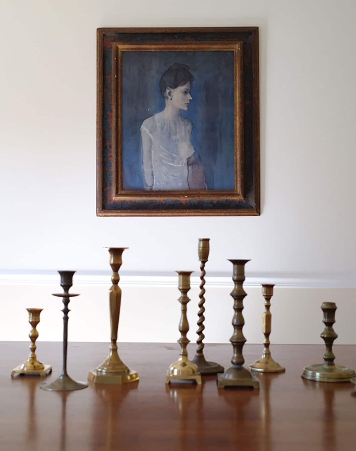 Girl in a Chemise Pablo Picasso portrait. Vintage brass candlesticks in my dining room. 