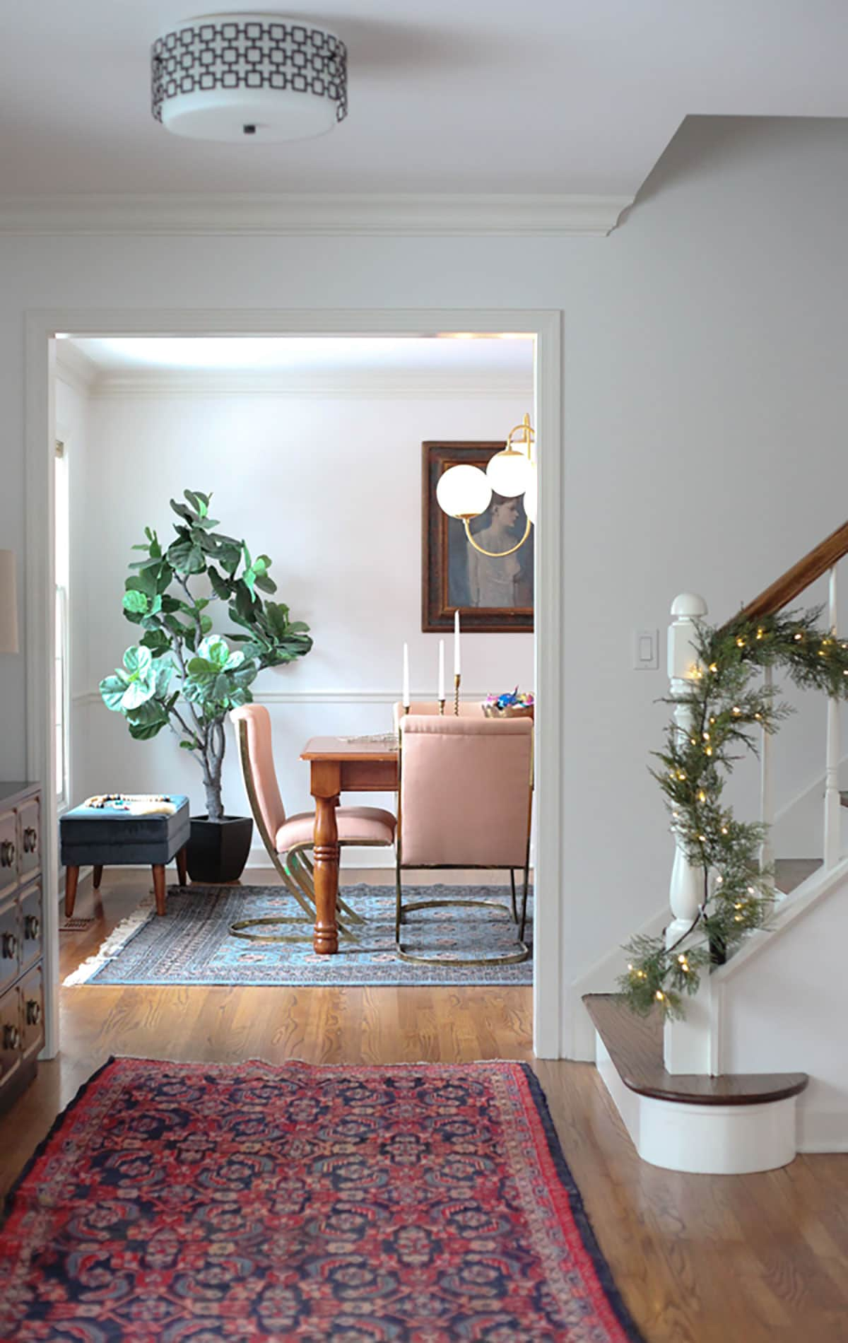 blogger holiday home tour - dining room decor and garland on banister