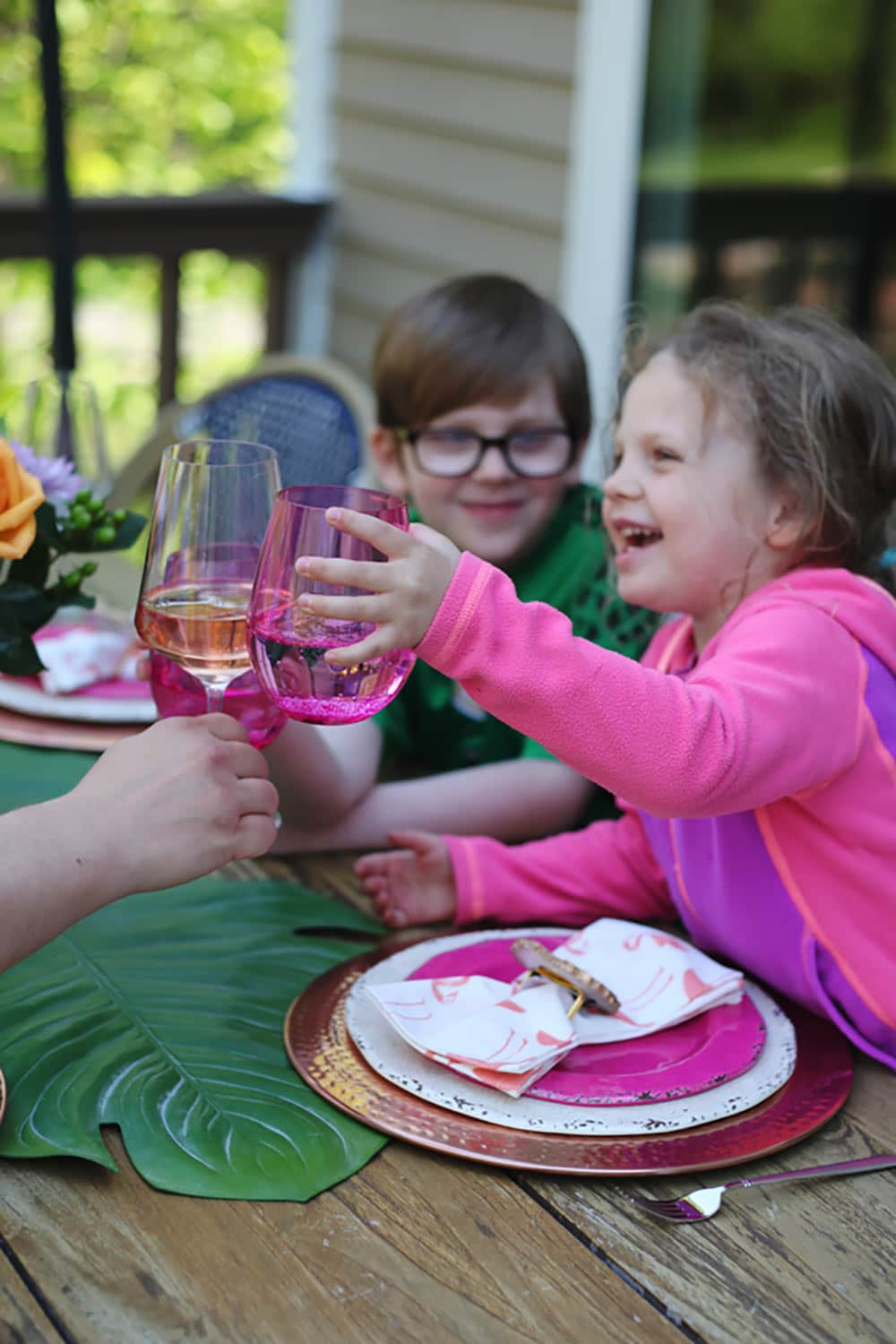 Outdoor Entertaining creating a colorful boho tablescape with pops of pink and blue. Outdoor patio furniture and decor