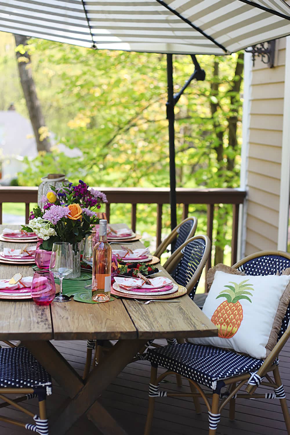 Outdoor Entertaining creating a colorful boho tablescape with pops of pink and blue. Outdoor patio furniture and decor
