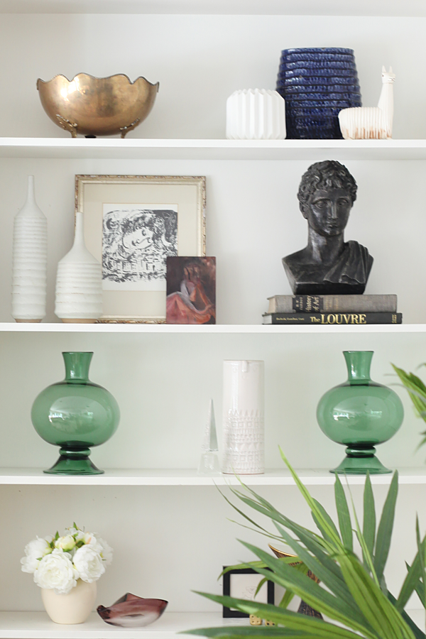 Shelf styling with vintage home decor. A pair of Sara Paloma stem vases from Everything But The House.