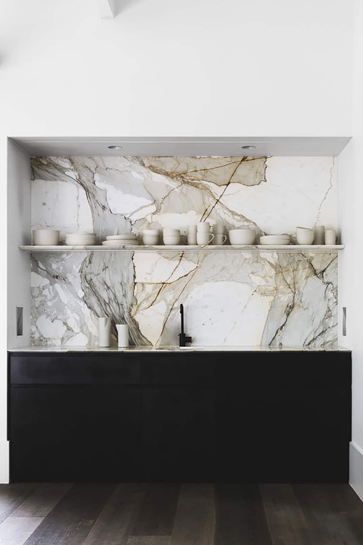 https://houseofhipsters.com/wp-content/uploads/2018/02/kitchen-makeover-marble-backslpash-modern-black-countertops.jpg