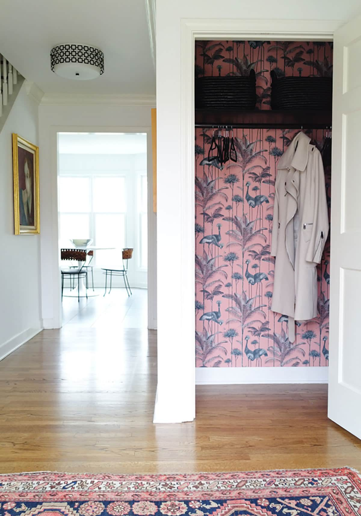 Pink wallpaper lining a closet