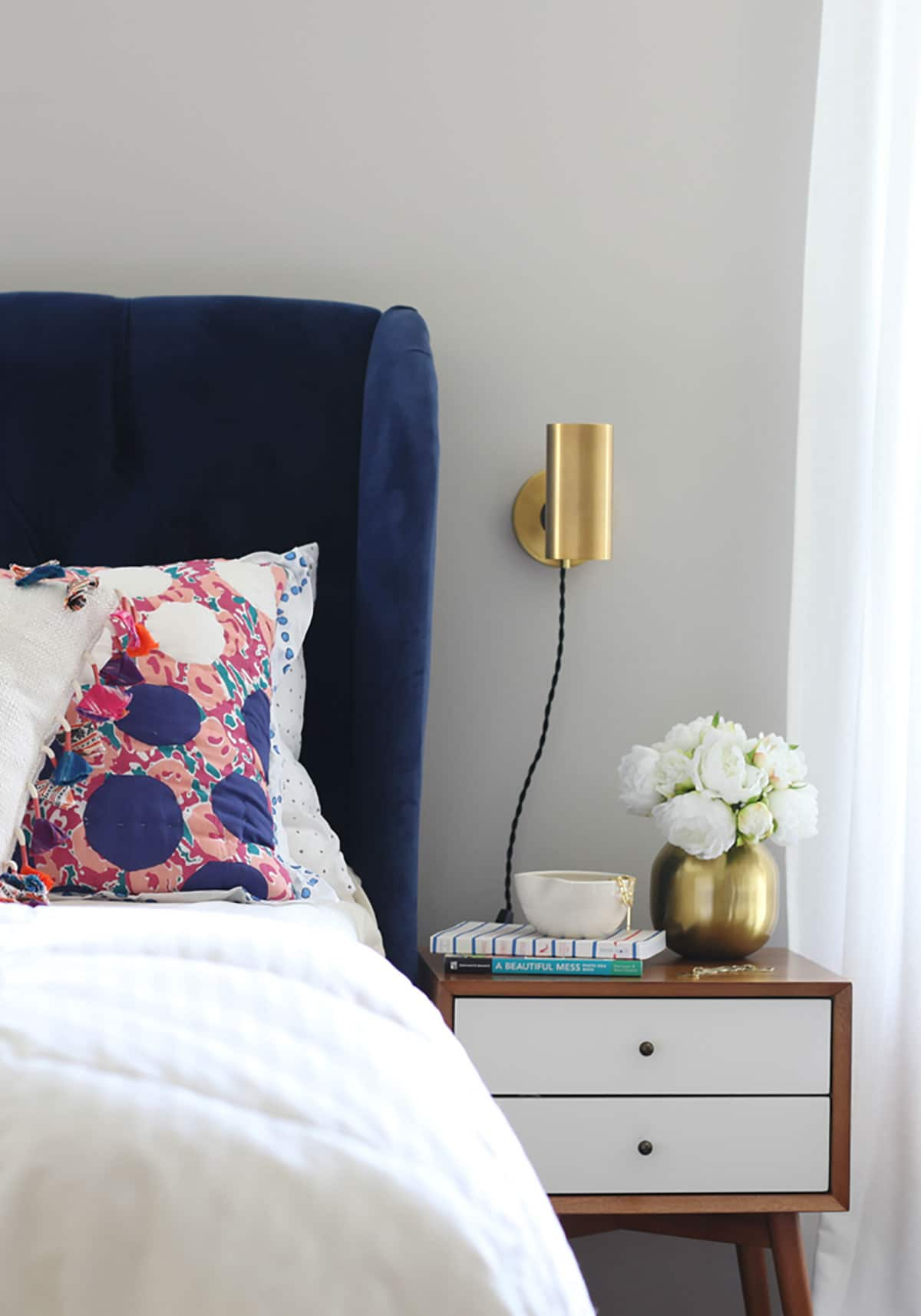 blue velvet headboard with mid century modern style decor interior design