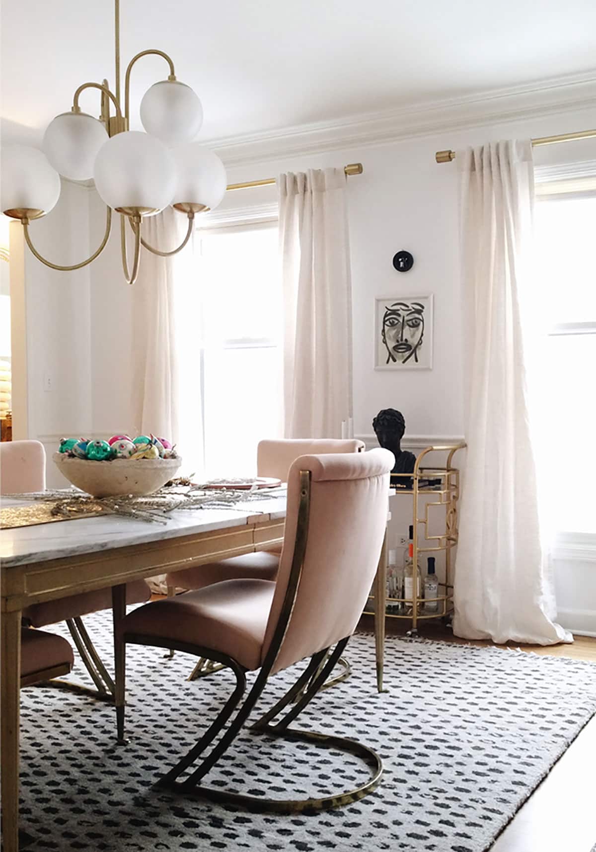 pink and brass cantilever chairs in eclectic dining room