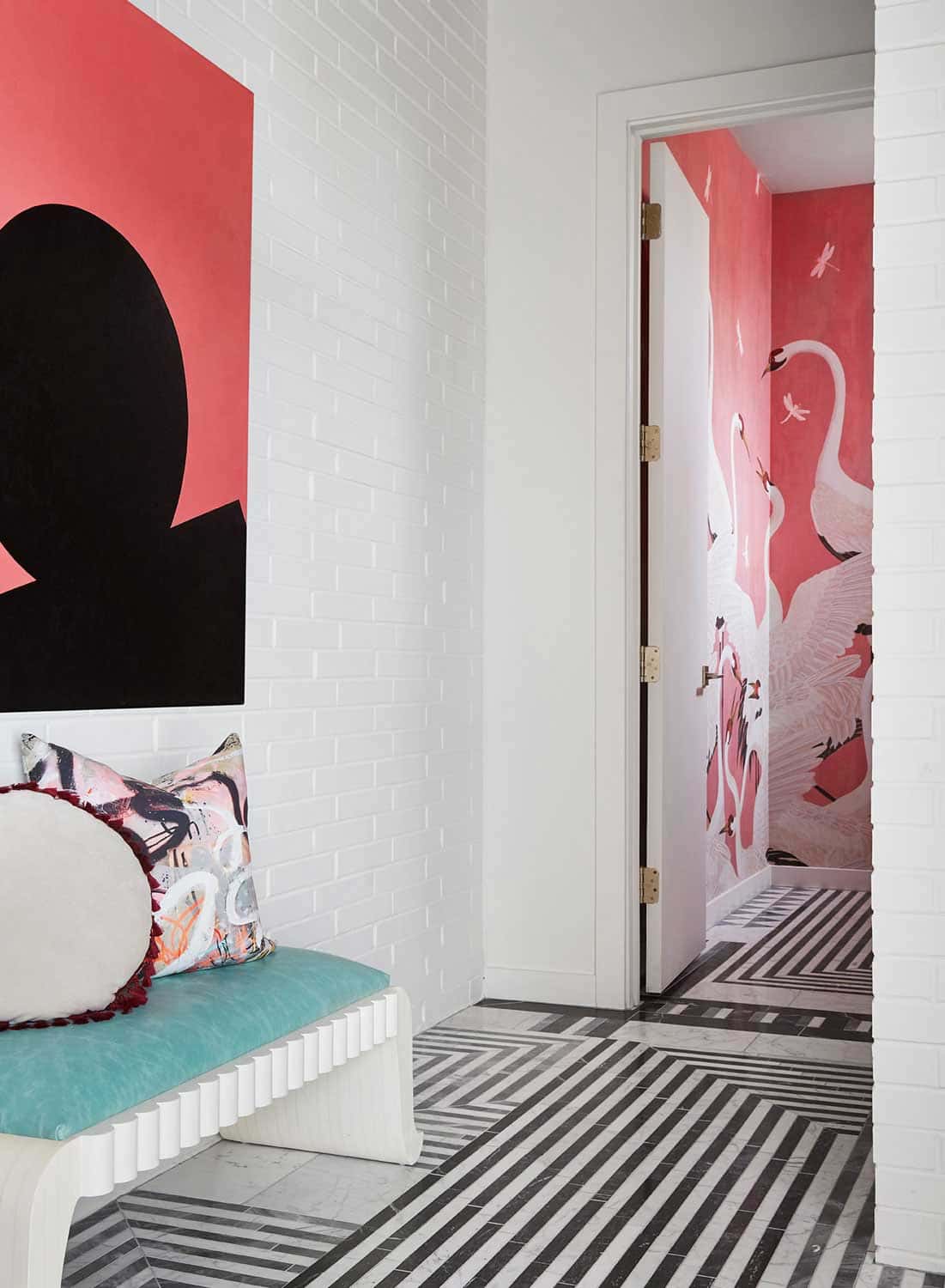 Off the foyer is a powder room with walls covered in pink Gucci swan wallpaper
