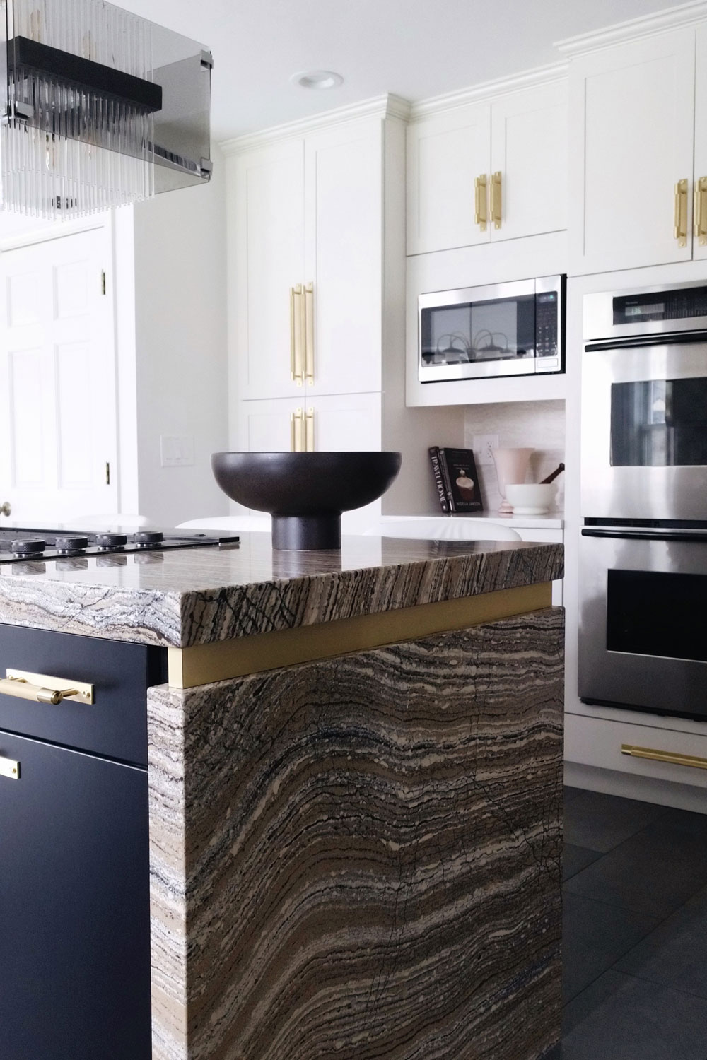 bold kitchen island design made of quartz with brass inlay
