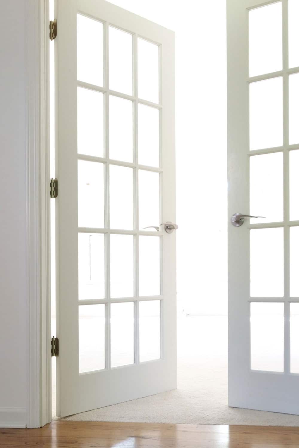 These white french doors will be painted black and new marble levers will replace the outdated hardware.