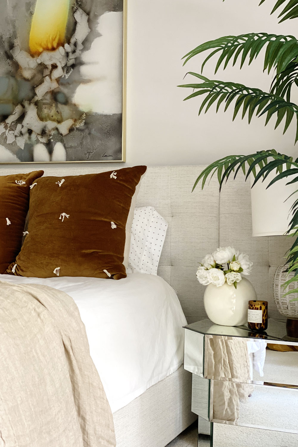 Ivory white upholstered headboard in primary bedroom