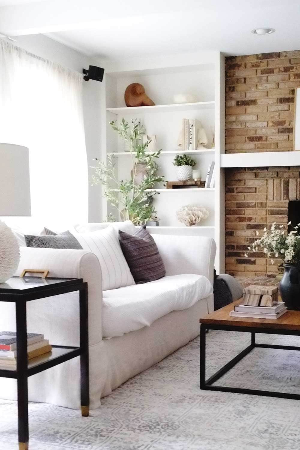 living room with brick fireplace