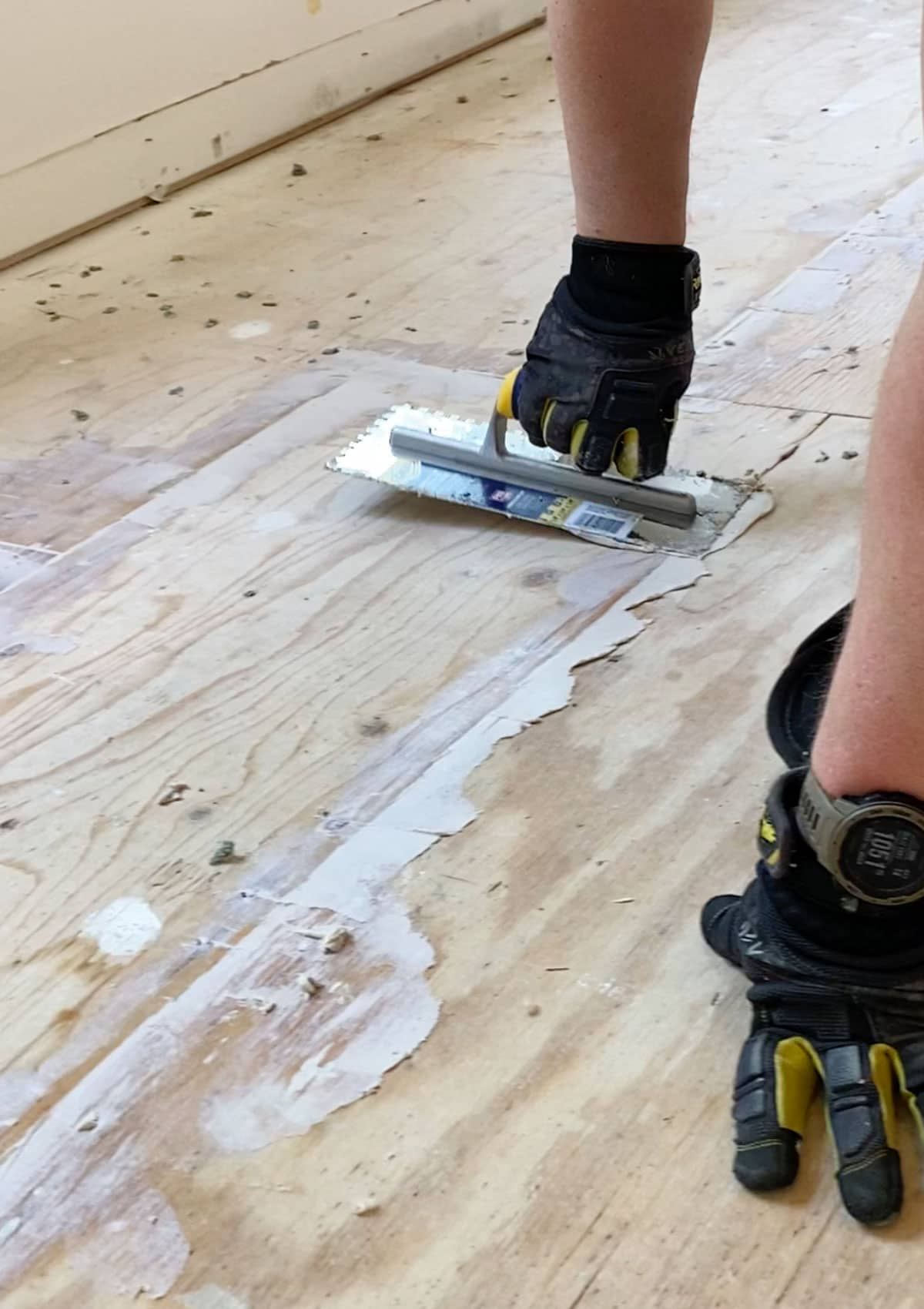 walk-in closet renovation - filling nail holes and seams in plywood before pouring the self leveling cement. 