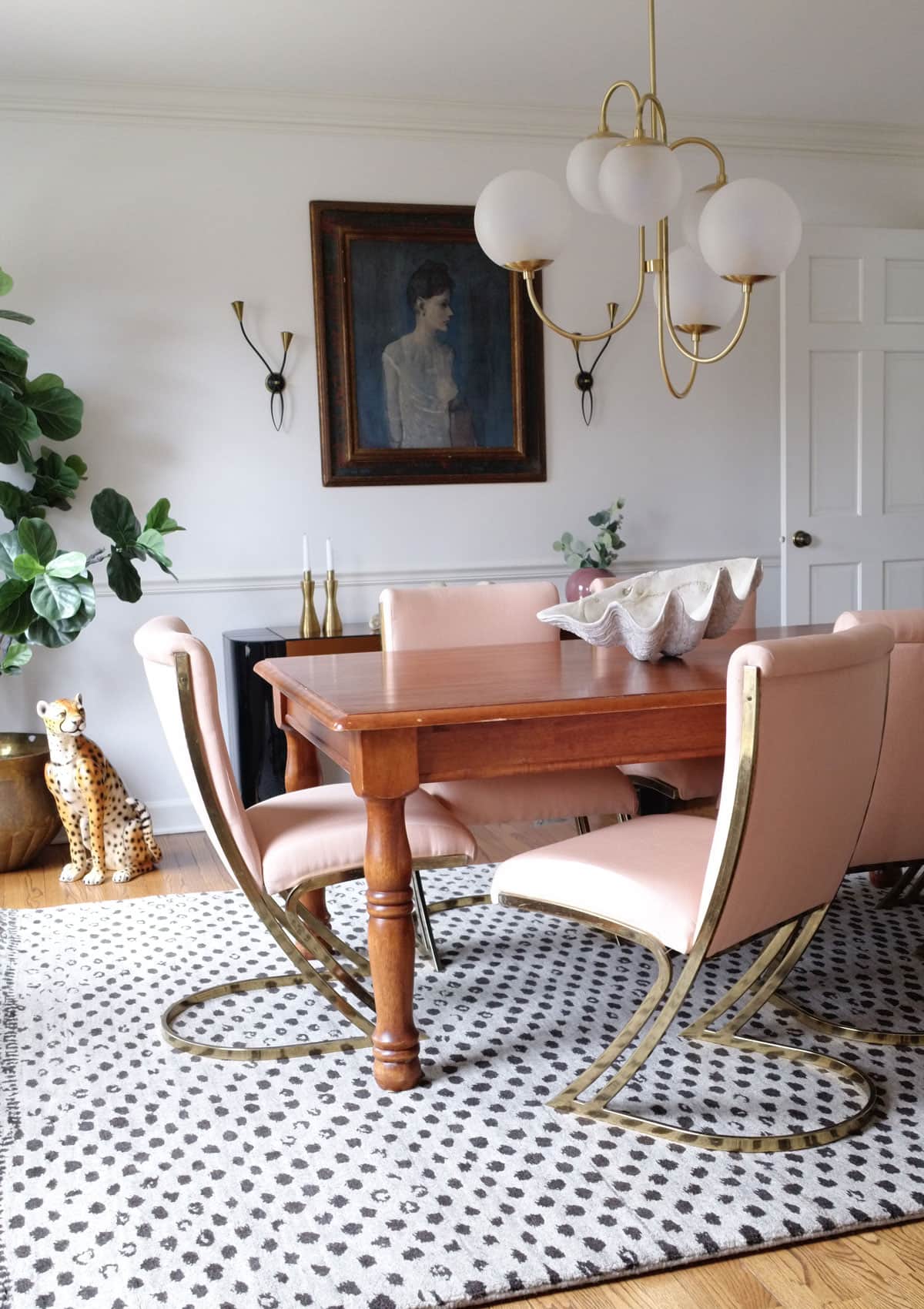 Eclectic Modern Dining Room Decor - Old pine wood table and vintage pink Pierre Cardin brass chairs in dining room with modern Annie Selke Hugo rug.