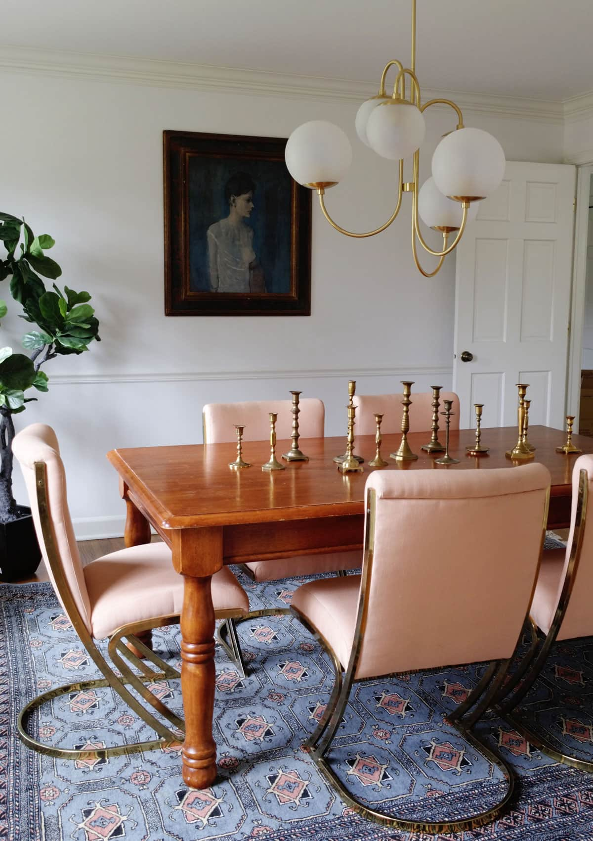 Eclectic Modern Dining Room Decor - Old pine wood table in dining room with vintage Pierre Cardin brass chairs create an interesting mix of decor styles. 