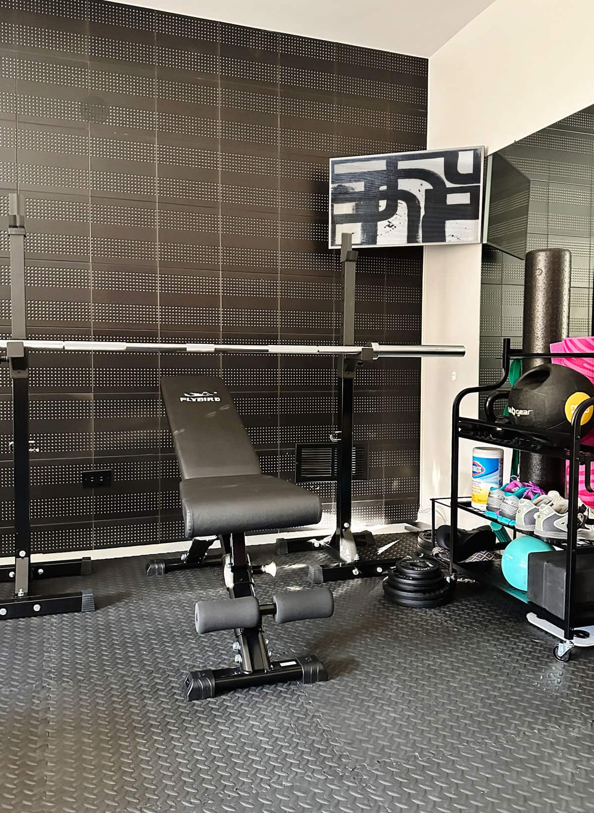 Mini Home Gym - Compact Ideas and Equipment - Small home gym room ideas with small space compact equipment. This weight bench folds up for easy small space storage.