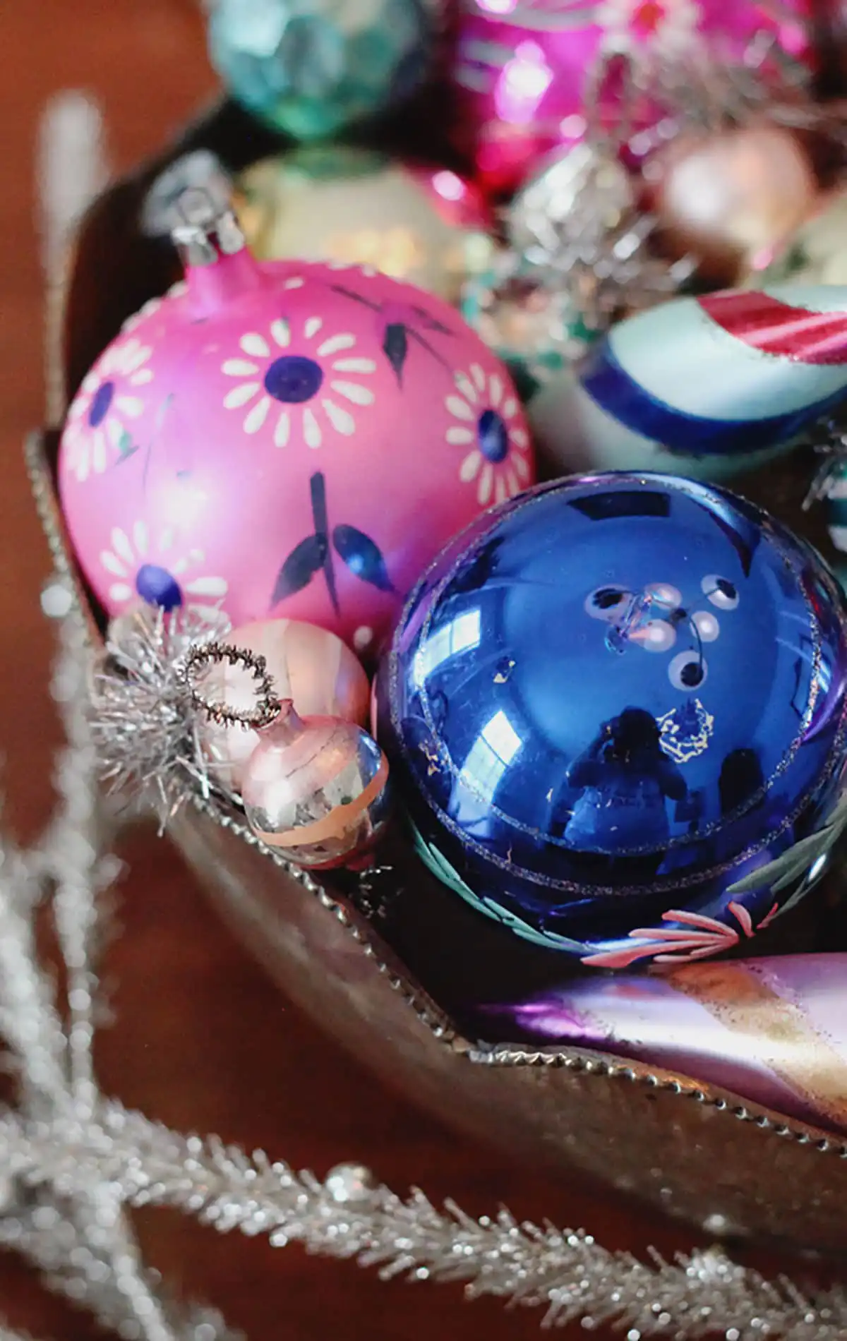 Tacky Christmas decor - style vintage ornaments in a brass bowl for a dining table centerpiece