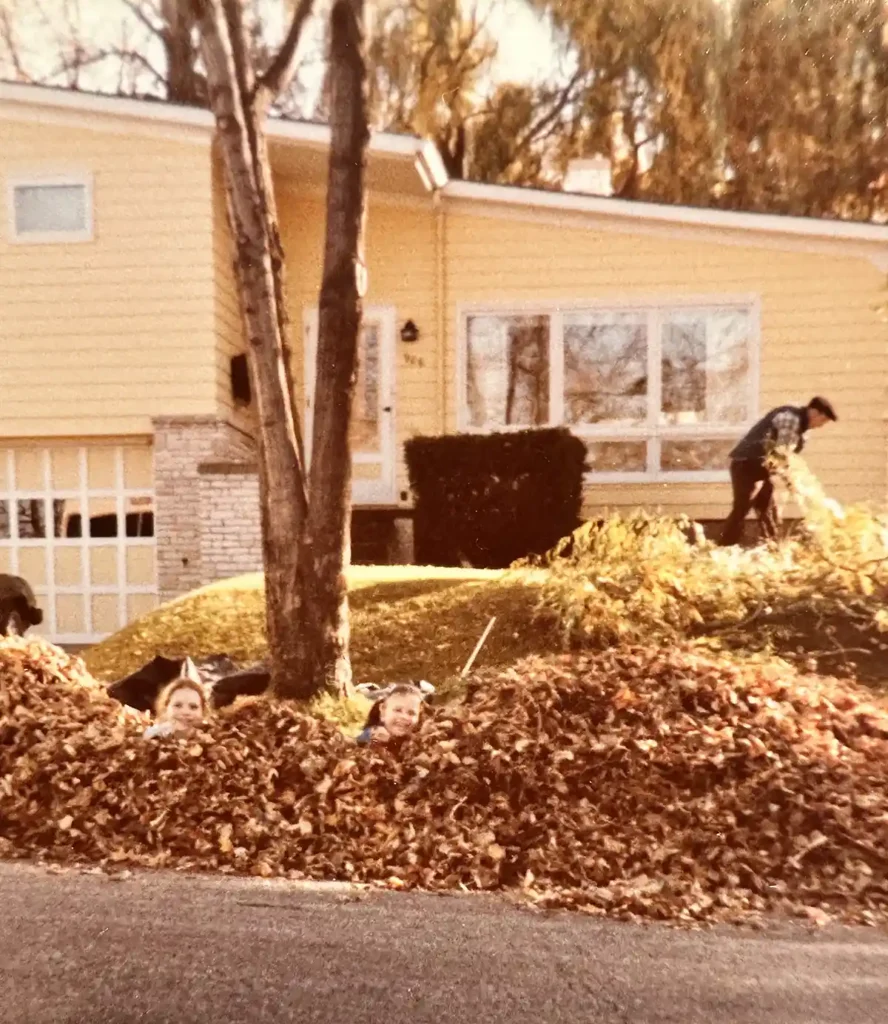 Buying my childhood home - me and my sister sitting in the fall leaves that my dad is raking